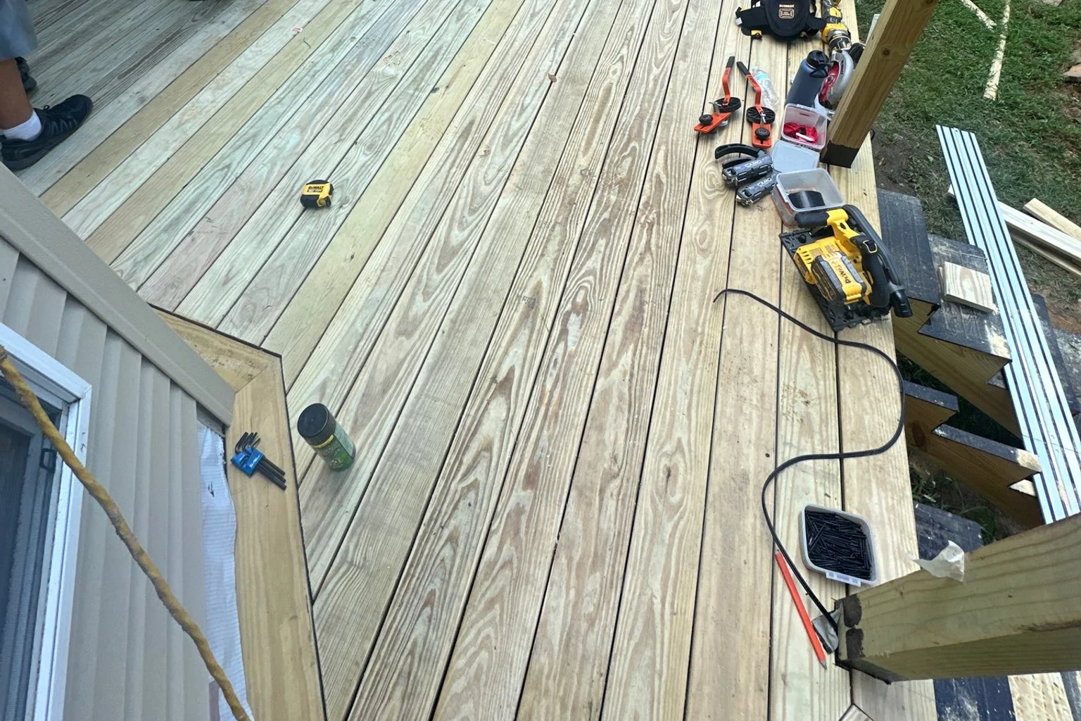Wood deck boards and tools during deck construction