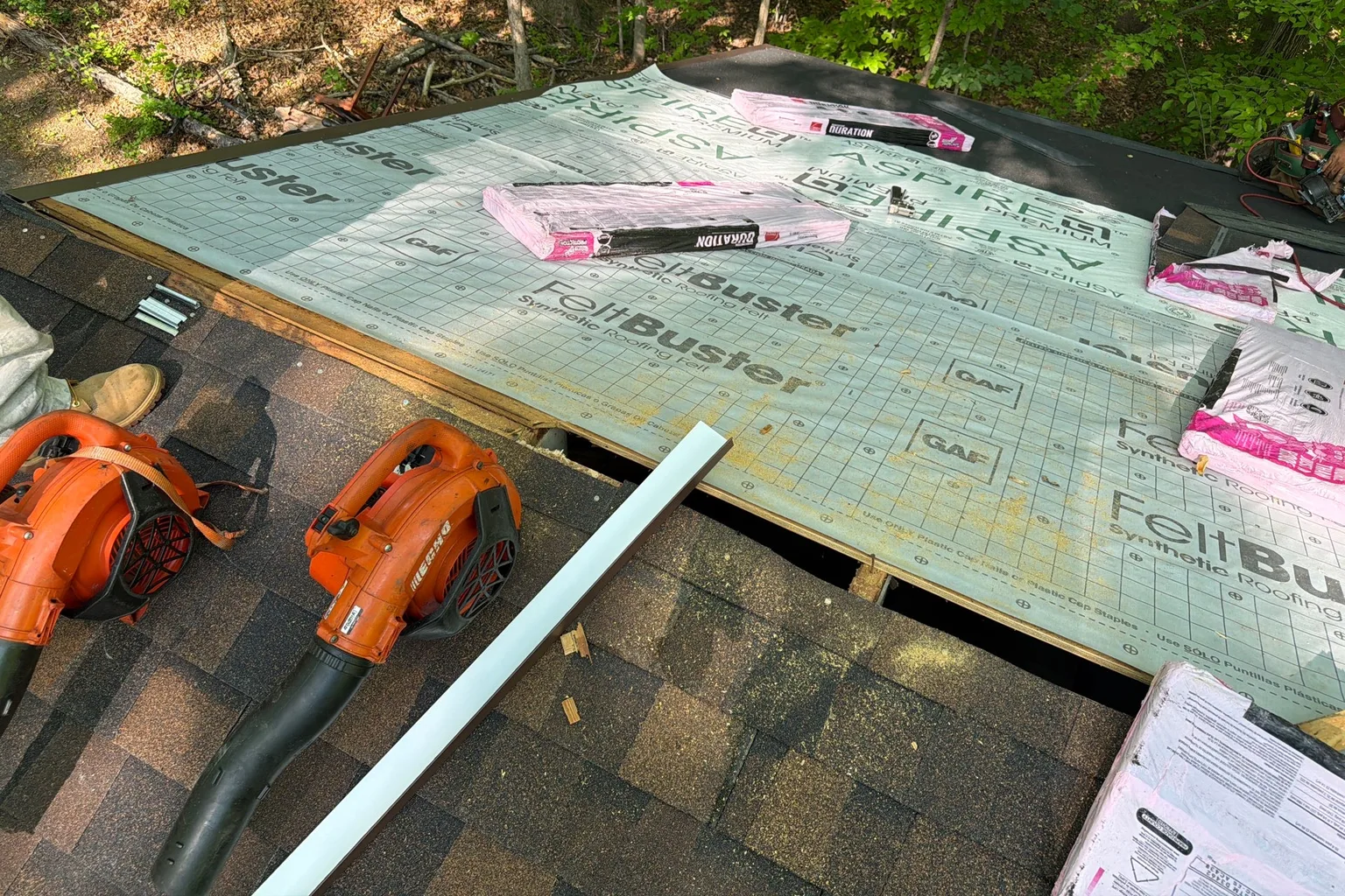 Roof replacement materials staged over protective underlayment